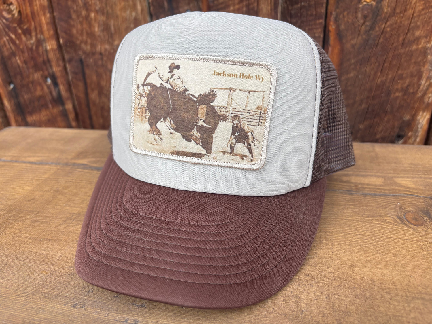Trucker hat with a bull riding photograph patch from the Jackson Hole rodeo grounds