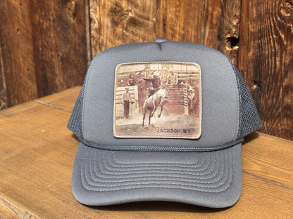 Decky mid profile trucker hat with the saddle bronc rodeo patch