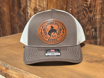 Trucker hat with a Jackson Hole rodeo buckle photograph patch