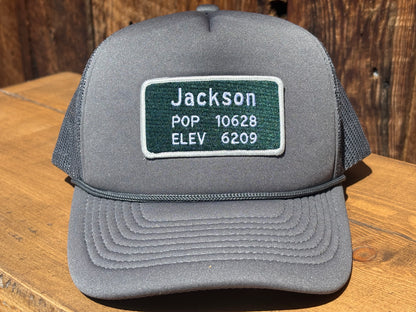 Jackson Hole trucker hat with a road sign patch